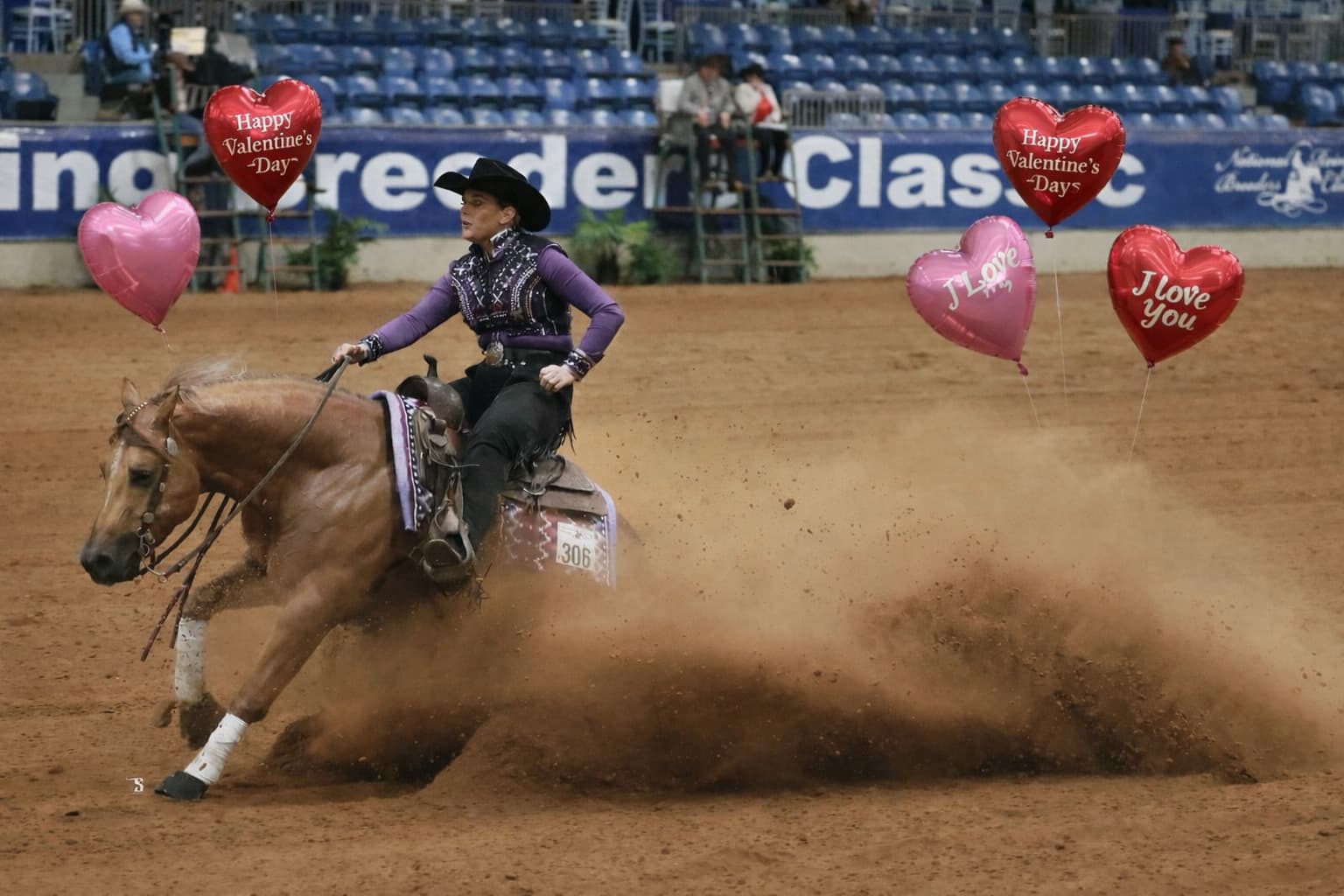 Cowgirl riding horse in arena
