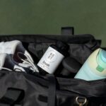 a bag with a bottle of water and shoes